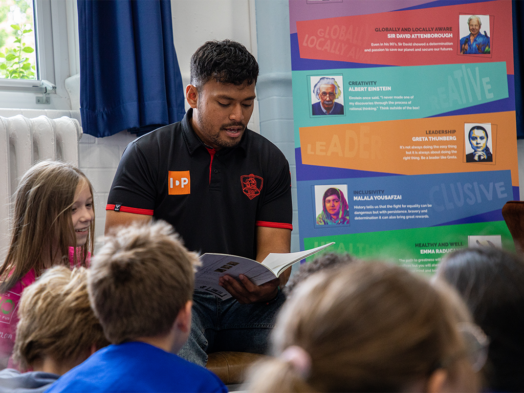Charter savings bank a rugby player reading to children